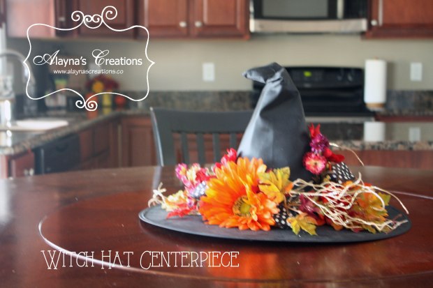 Witch Hat Centerpiece dress up an inexpensive costume hat with some silk flowers leaves and ribbon to make your own lovely centerpiece for your Halloween table or party